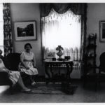Progress Club members Mrs. Murray Klingaman and Mrs. Anthony Proto relax during an antiques exhibition held in the library community room in 1961. The event was a fundraiser for the third and final extension of the library building at Hawthorne and Adams. (Bethlehem Public Library archives)