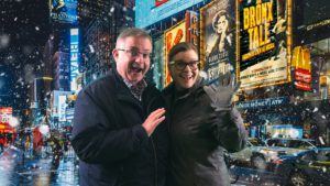 man and woman with NYC background