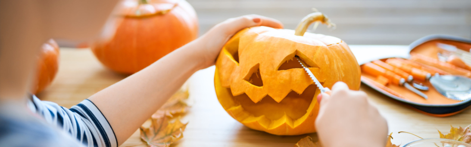 Woman is carving pumpkin